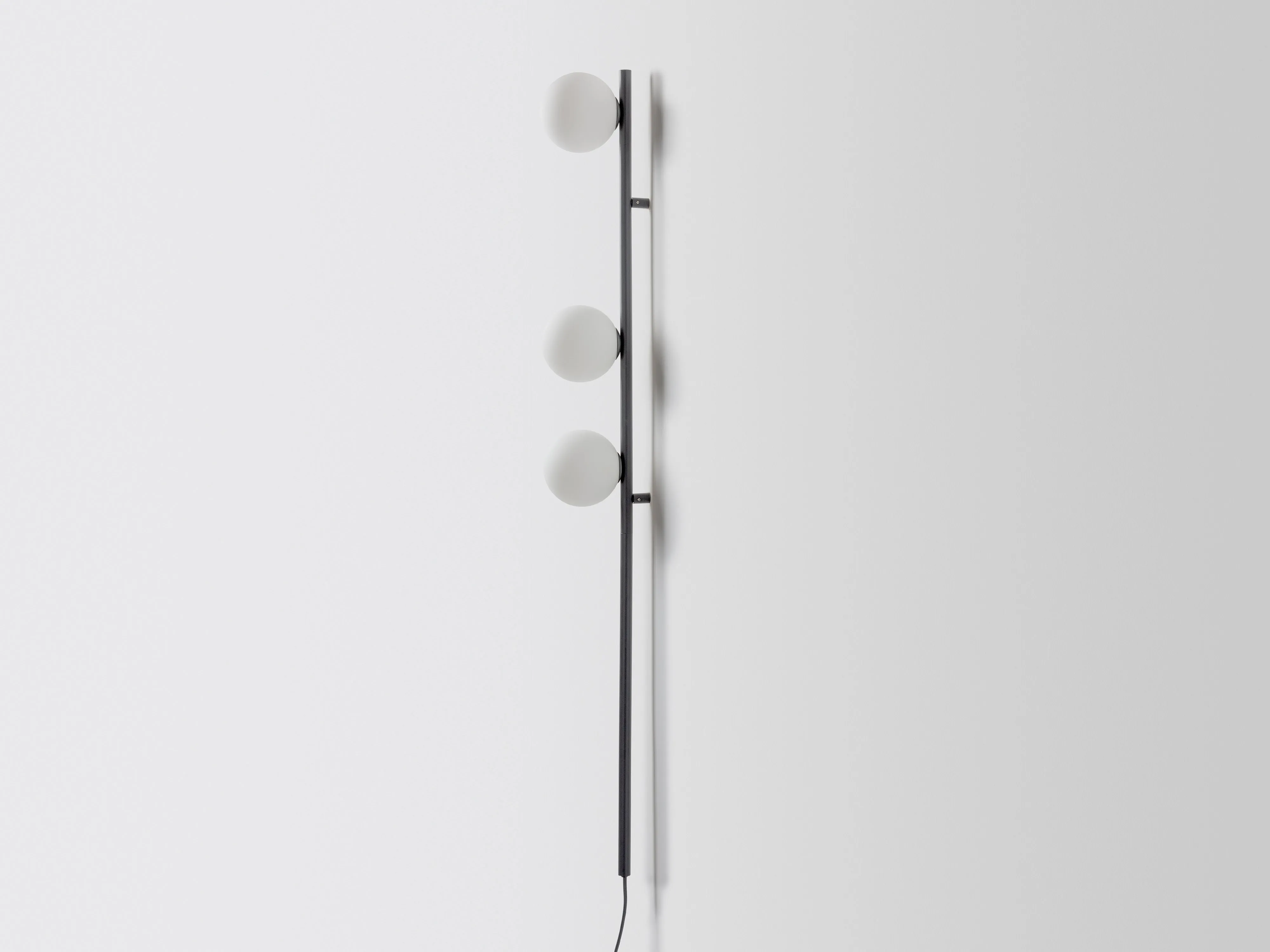 Charcoal grey bar opal ball wall light